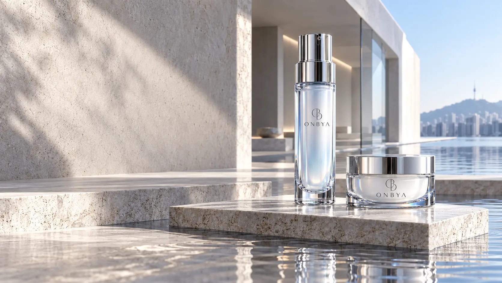 ONBYA Renewal Serum and Barrier Cream design concepts in clear glass and polished silver with the OB symbol, photographed against limestone architecture
